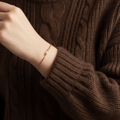 Armband in Gold mit kleiner Muschelkernperle, Edelstahl