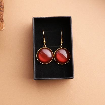 Ohrringe in Gold mit rundem braunen Stein aus Edelstahl (2 cm)