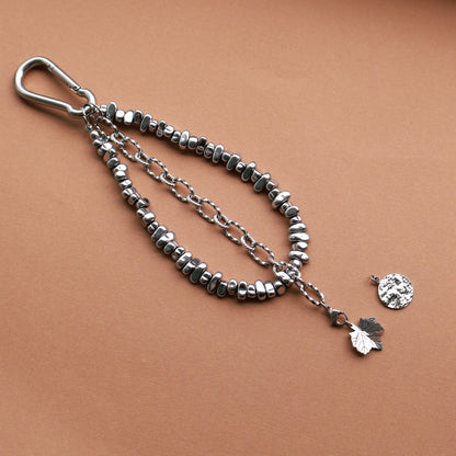 Taschenanhänger aus Edelstahl und Hämatitperlen in Silber mit mit 2 wechselbaren Anhängern